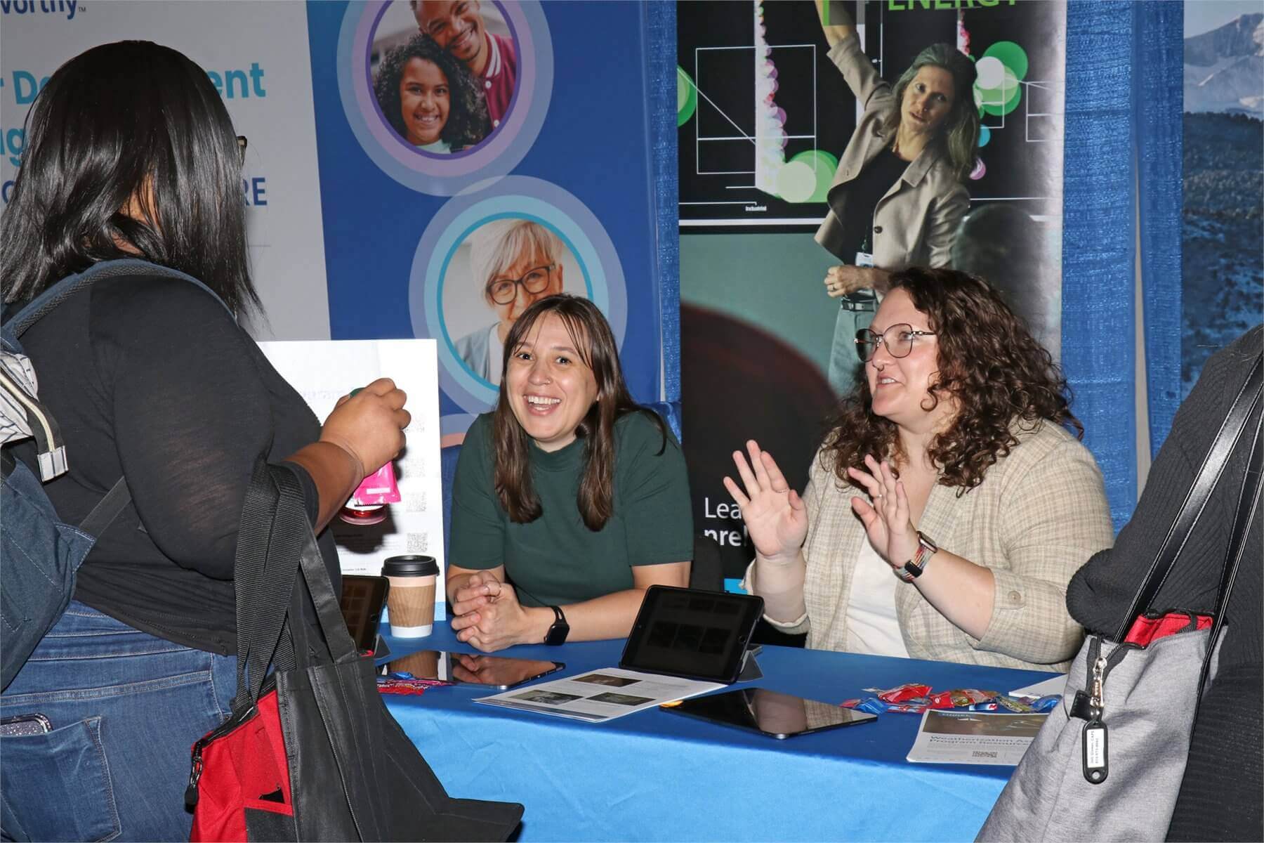 Conference attendee conversing with an exhibitor