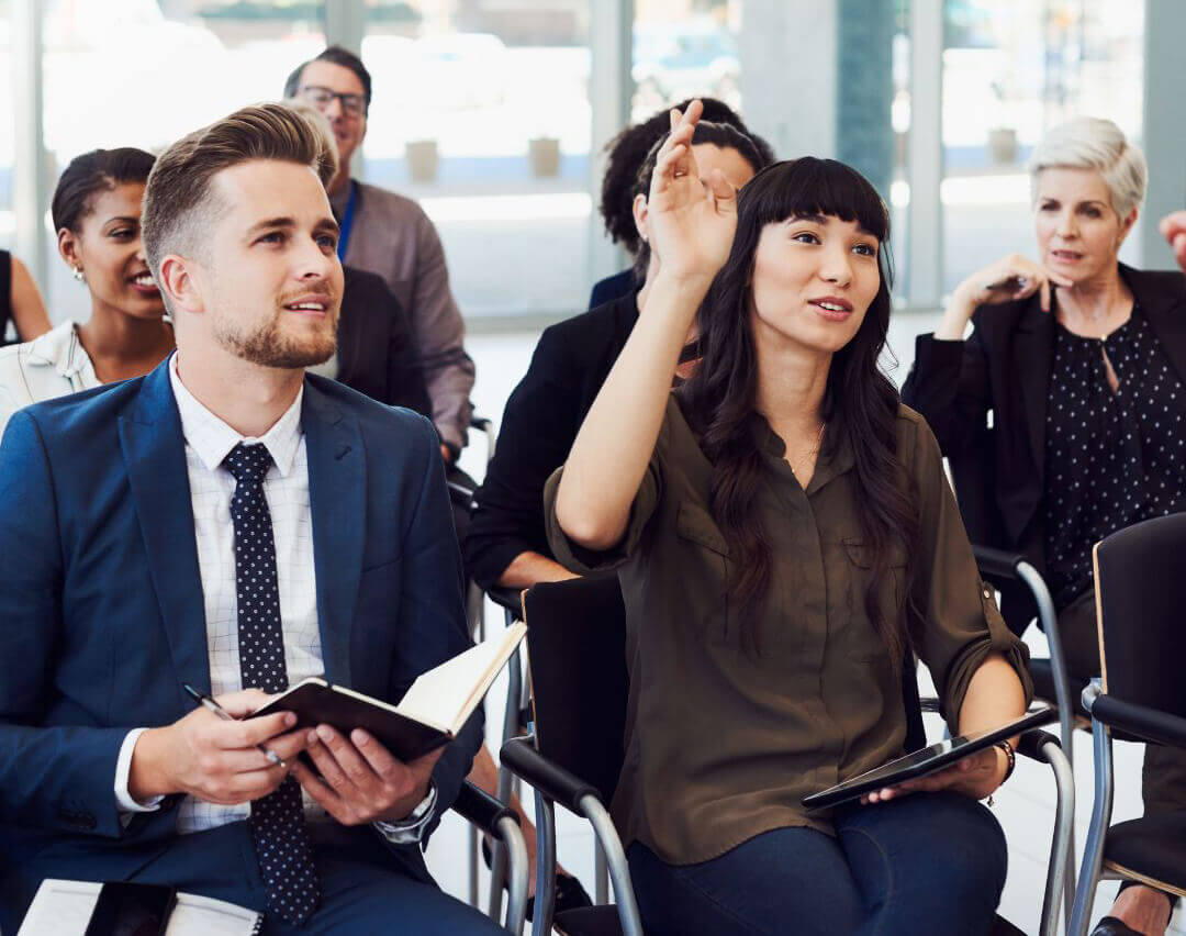 Conference attendee raising her hand