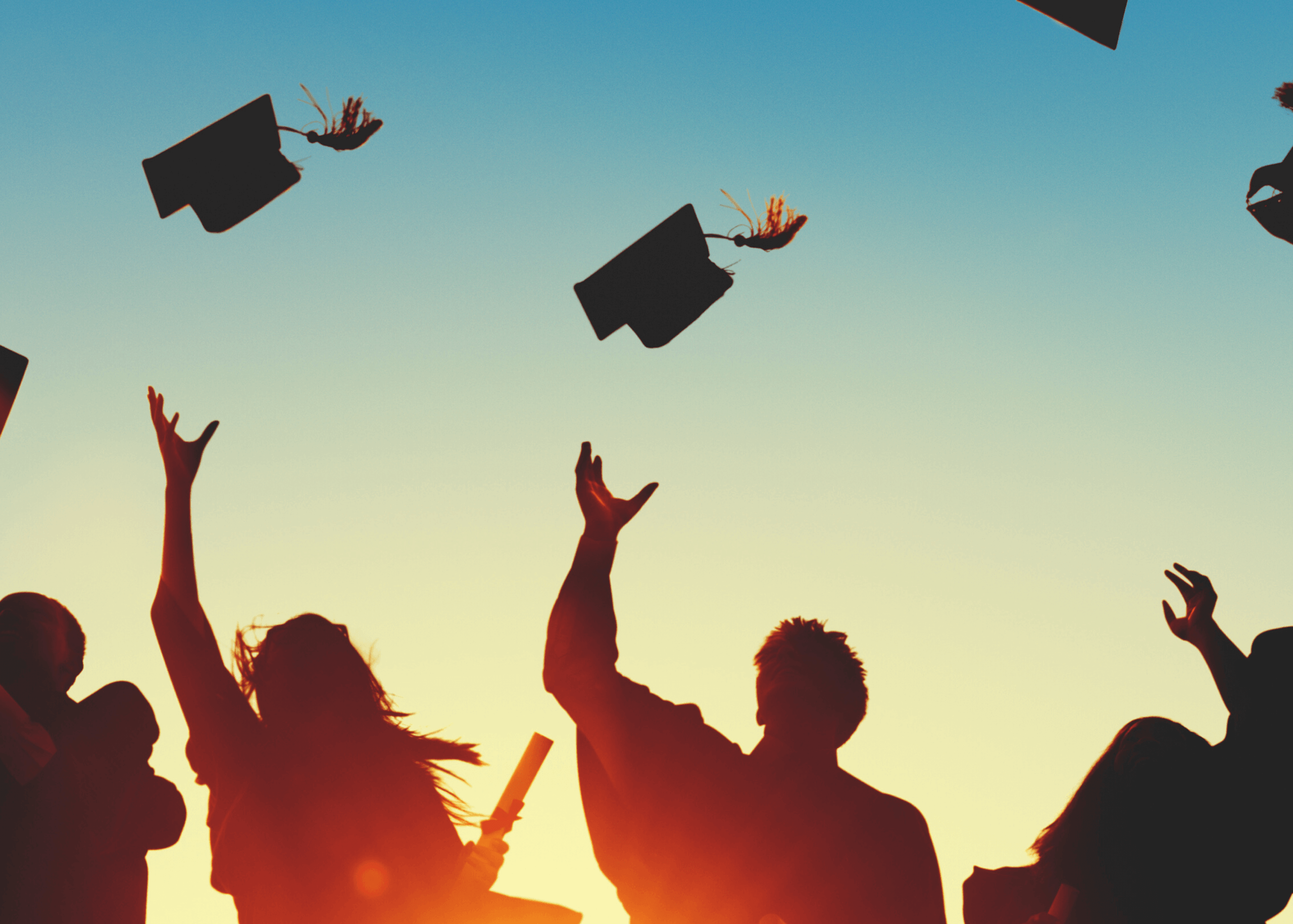 Graduates throwing their caps in the air. 